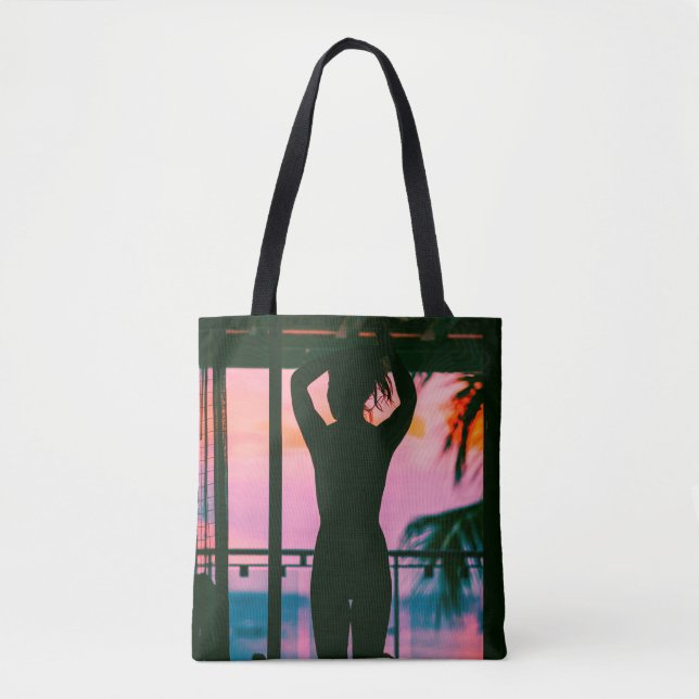 Woman in black tank top and pants standing on blac tote bag (Front)