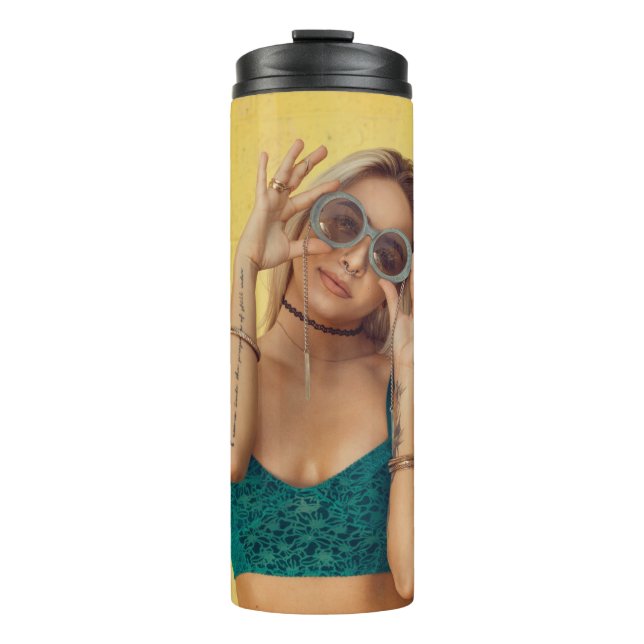 Woman in blue bralette holding sunglasses putting  thermal tumbler (Front)
