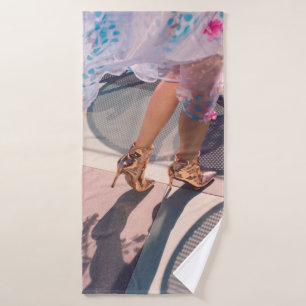 Woman in white pink and green floral skirt and bro bath towel