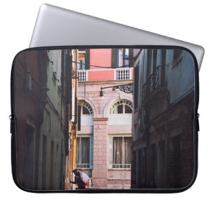 WOMAN IN WHITE SHIRT AND BLACK PANTS WALKING ON SI LAPTOP SLEEVE