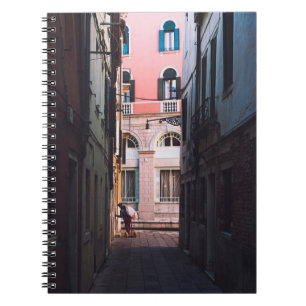 WOMAN IN WHITE SHIRT AND BLACK PANTS WALKING ON SI NOTEBOOK