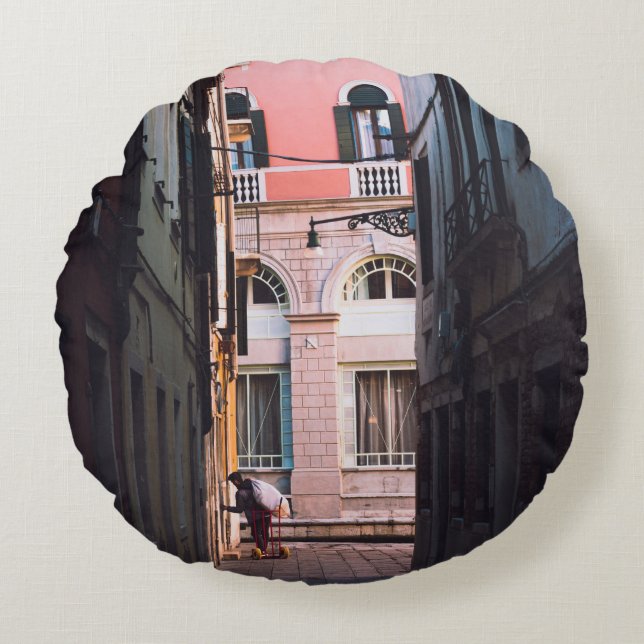 WOMAN IN WHITE SHIRT AND BLACK PANTS WALKING ON SI ROUND CUSHION (Front)