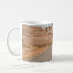 Woman in white shirt running on road in the mornin coffee mug