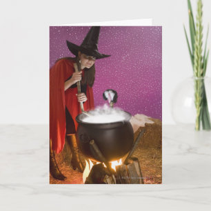 Woman in witch costume stirring caldron card