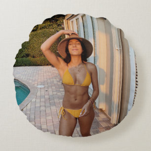 Woman in yellow bikini standing on brown brick flo round cushion