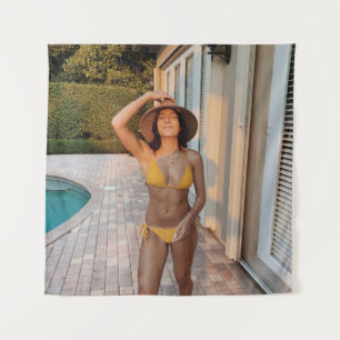 Woman in yellow bikini standing on brown brick flo tapestry