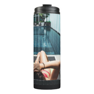 Woman laying on brown chaise lounge thermal tumbler