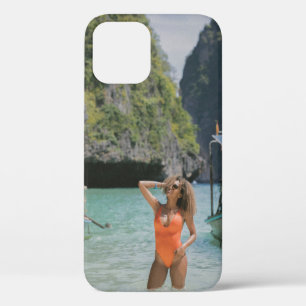 Woman on body of water between brown boats iPhone 12 case