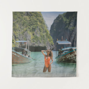 Woman on body of water between brown boats tapestry