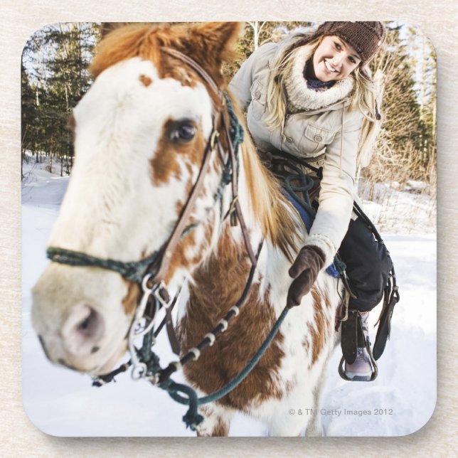 Woman on horse outdoors during winter coaster (Front)