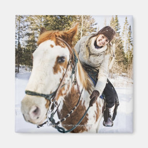 Woman on horse outdoors during winter magnet