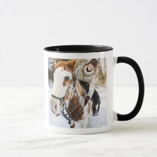 Woman on horse outdoors during winter mug
