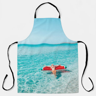 Woman on lilo in the sea water. Girl relaxing on i Apron