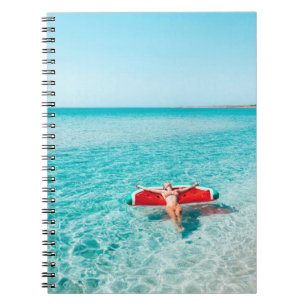 Woman on lilo in the sea water. Girl relaxing on i Notebook