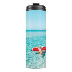 Woman on lilo in the sea water. Girl relaxing on i Thermal Tumbler