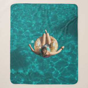 Woman on yellow inflatable floater sherpa blanket