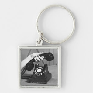 Woman picking up phone close up of hand key ring