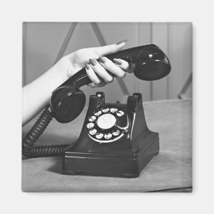 Woman picking up phone close up of hand magnet