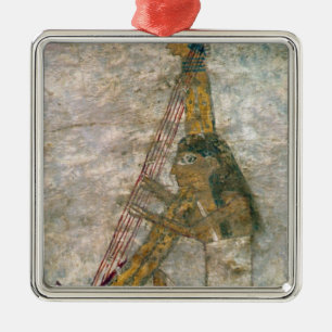 Woman playing an arched harp metal ornament