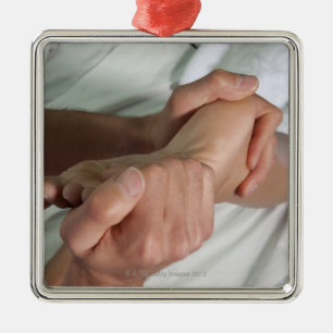 Woman receiving foot massage 2 metal ornament