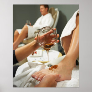 Woman receiving foot massage with oil poster