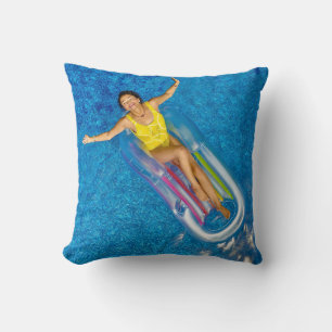 Woman riding on plastic floating buoy on body of w cushion