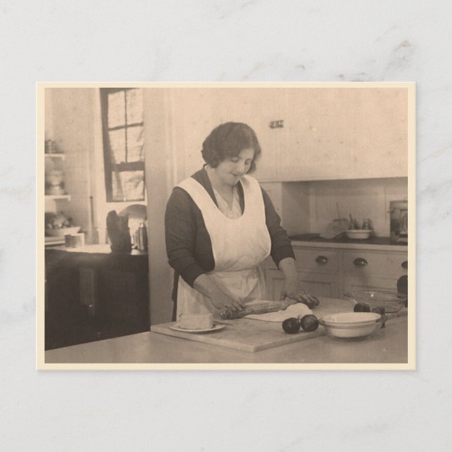 Woman rolling dough in a vintage kitchen postcard (Front)