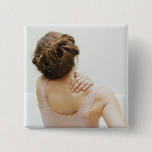 Woman rubbing aching back 15 cm square badge