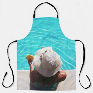 Woman sitting beside swimming pool apron