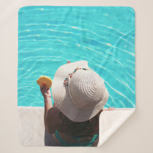 Woman sitting beside swimming pool sherpa blanket