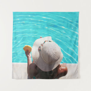 Woman sitting beside swimming pool tapestry