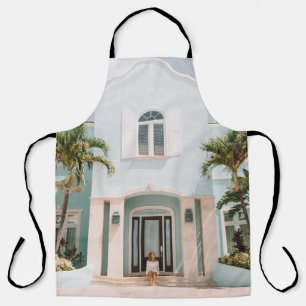 Woman sitting in front of building apron