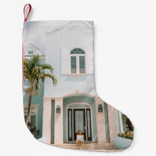 Woman sitting in front of building small christmas stocking