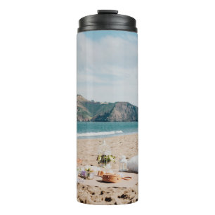 Woman sitting near seashore while looking at Golde Thermal Tumbler
