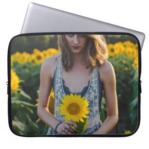 Woman standing at sunflower field laptop sleeve