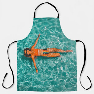 Woman swimming alone in body of water apron
