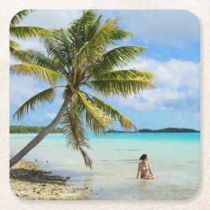 Woman under a palm tree in the Pacific coaster