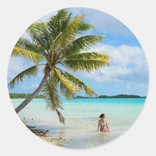Woman under a palm tree round sticker