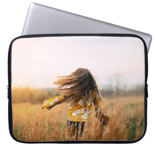 Woman walking on field at daytime laptop sleeve