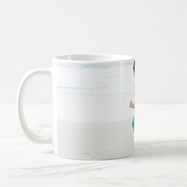Woman walking on shore near beach coffee mug (Left)