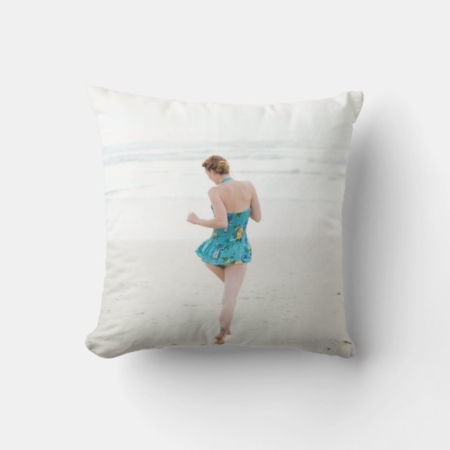 Woman walking on shore near beach cushion (Front)