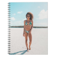 Woman wearing bikini standing on sand