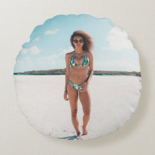 Woman wearing bikini standing on sand round cushion