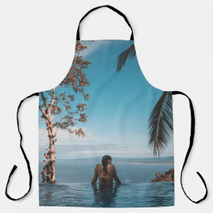 Woman wearing black bikini tap swimming on body of apron