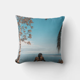 Woman wearing black bikini tap swimming on body of cushion