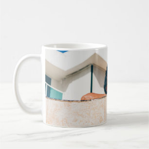 Woman wearing black sunglasses coffee mug