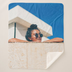 Woman wearing black sunglasses sherpa blanket