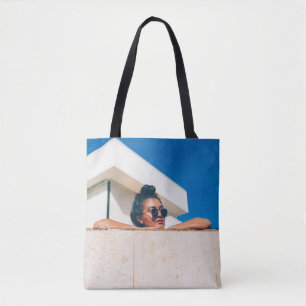Woman wearing black sunglasses tote bag