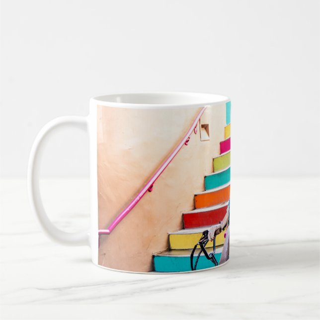 Woman wearing blue denim jacket and shorts riding  coffee mug (Left)