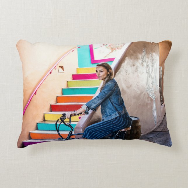 Woman wearing blue denim jacket and shorts riding  decorative cushion (Front)